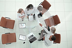 Top view.handshake financial partners before the business meeting