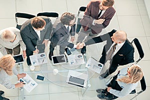 Top view. handshake of financial partners at a working meeting.