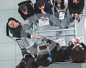 top view. handshake of financial partners at a working meeting.