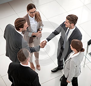 Top view.handshake trading partners in the office