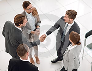 top view.handshake trading partners in the office