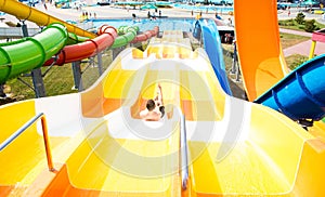 Top view of happy crazy man on top of slide in aqua park - Young people having fun in summer holidays