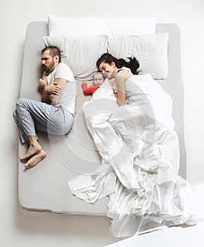 Top view of happy family with one newborn child in bedroom.