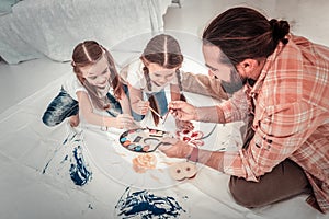 Top view of a happy father drawing with his kids photo