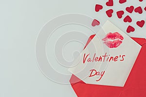 top view of happy valentines day postcard with lips print in envelope