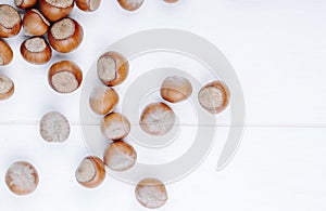 top view of hazelnuts scattered on white background with copy space