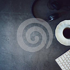 Top view headphone, white coffee cup and keyboard with copy space