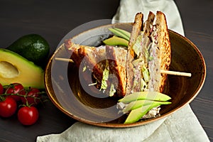 Top view of Healthy Sandwich toast with lettuce, ham, cheese and tomato on a wooden background