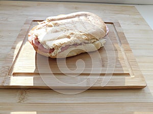 Top view of Healthy Sandwich toast with lettuce, ham, cheese and tomato on a wooden background