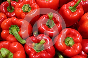 Top View of Heap of Fresh Ripe Red Bell Peppers with Green Stem