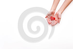 Top view of heart in hands on a white background with copy space. Greeting card for Valentine`s Day