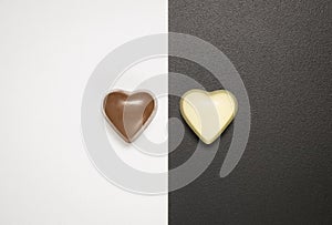 Top view of heart shaped chocolate bars on black and white