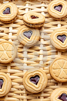 Top view of heart-shaped cookies and strawberry jam, on basket, for Valentine`s Day