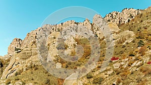 Top view of high mountain range in colorful autumn with green yellow meadows and rocky mountain peaks. Shot. View of