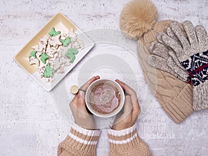 Top view of holding hot cocoa with crackers