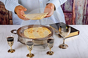 Holy communion on wooden table in church. Cup of glass with red wine, prayer for bread