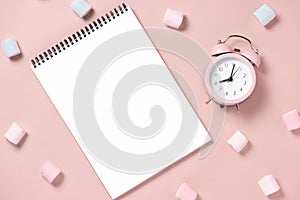 Top view, home office workspace with open notebook and snacks.