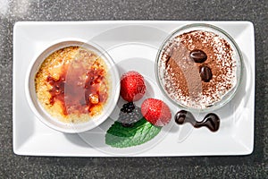 Top view of homemade food, creme brulee and chockolate cream with strawberry and mint leave,  creme brulee is a popular dessert,