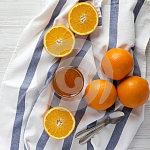 Top view, homemade orange marmelade on a white wooden surface. Flat lay, overhead, from above. Closeup