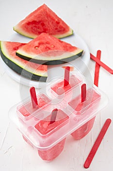 Top view of homemade watermelon popsicles with watermelon slices