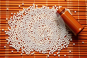 top view of homeopathic globules scattered on a bamboo mat