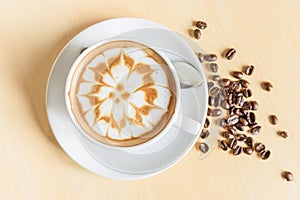 Top view of hot cappuccino on wood table