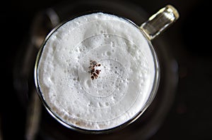 Top view of hot coffee cappuccino cup with milk foam