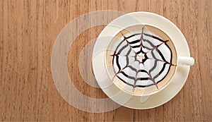 Top view of hot coffee cappuccino latte art on wooden table
