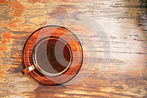 Top view,Hot coffee cup on glass cup on wooden table background