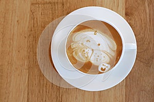 Top view of hot coffee latte cup with cute pug dog latte art mil