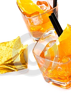 Top of view of hot tacos chips in front of two glasses of spritz aperitif aperol cocktail with orange slices and ice cubes