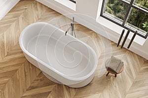 Top view of hotel bathroom interior with bathtub and panoramic window