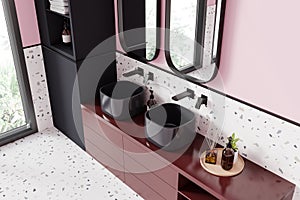 Top view of hotel bathroom interior with double sink and accessories, window