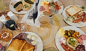 Top view of hotel breakfast buffet table with plates