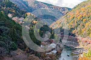 Top view of Hozugawa river with japanese traditional wooden house , boat and autumn foliage colors from Arashiyama view point, Kam