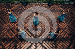 Top view of hula dancers in Honolulu in a beautiful setting and charming blue clothes