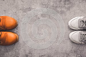 Top view of human shoes at a distance from each other on a gray concrete background. Compliance with a distance of 2 meters with