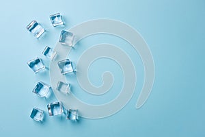 top view of ice cubes of different sizes on blue background