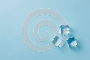 top view of ice cubes of different sizes on blue background