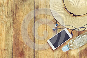 Top view image of beach accessories on wooden deck