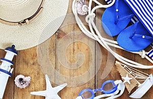 Top view image of beach accessories on wooden deck