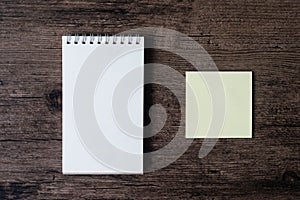 Top view image of blank notebook and empty sticky note paper on