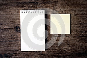 Top view image of blank notebook and empty sticky note paper on