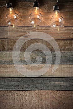 Top view image with bulblight garland on raw rustic background.