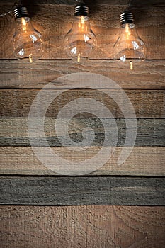 Top view image with bulblight garland on raw rustic background. photo