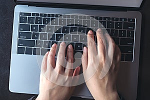 Top view image of business woman`s hands typing on laptop