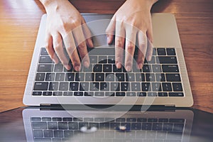 Top view image of business woman`s hands typing on laptop