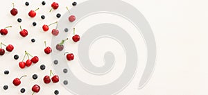 Top view image of colorful assorted mix of berries, blueberry and sweet cherry over wooden white background