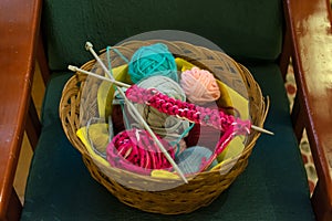 A top view image of crochet yarn and hook on a sofa