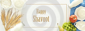 Top view image of dairy products and fruits on wooden background. Symbols of jewish holiday - Shavuot.